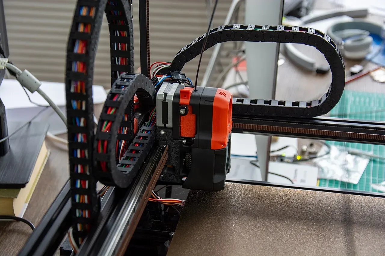 A Voron toolhead riding on its gantry with cable chains