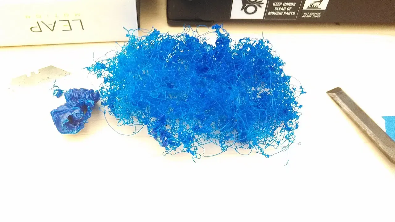 A failed print turned into a tangle of blue filament spaghetti