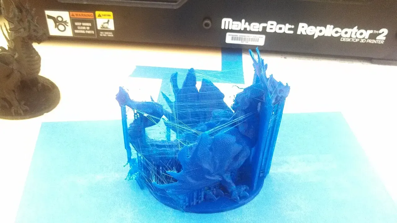 A blue dragon print covered in fine plastic strings