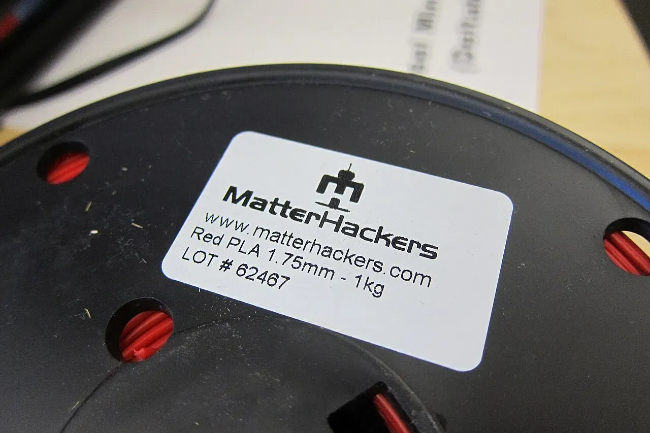 A filament spool label showing material, diameter and weight