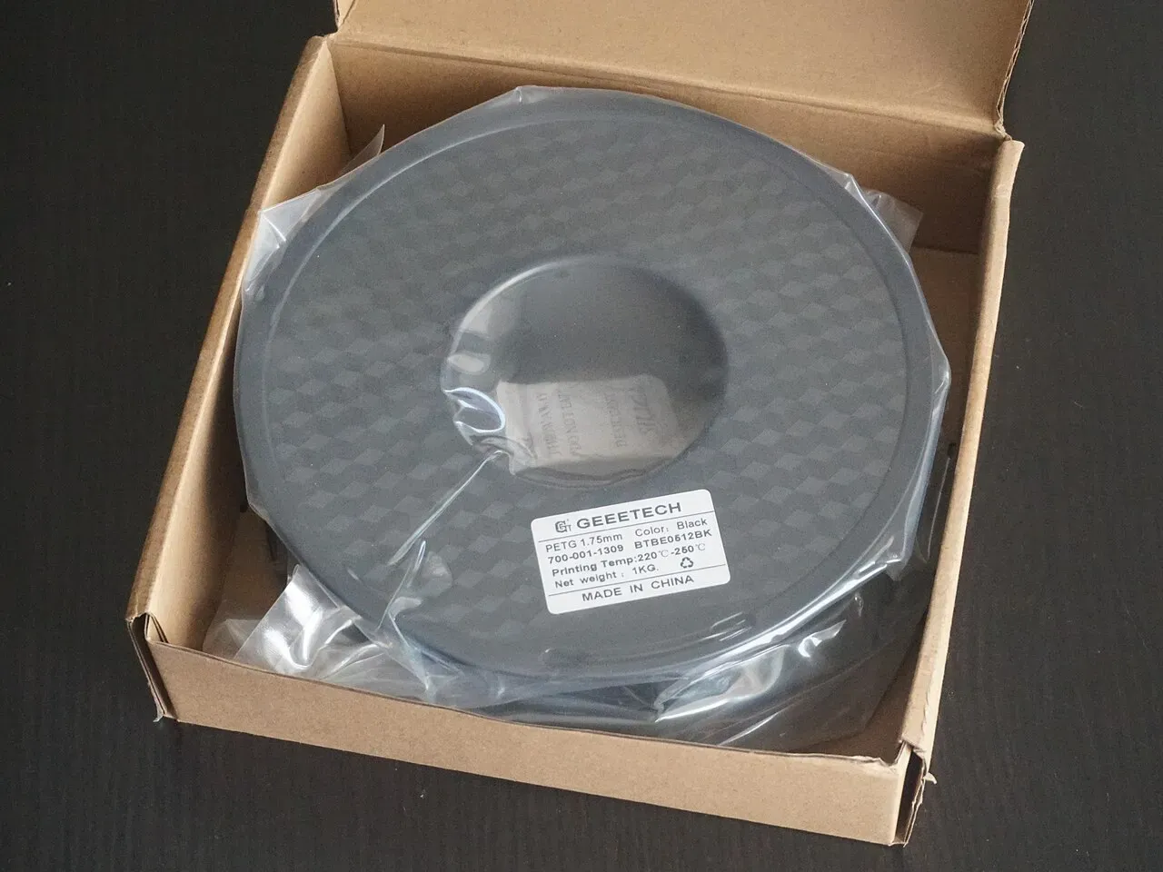A 1 kg spool of PETG filament in its box