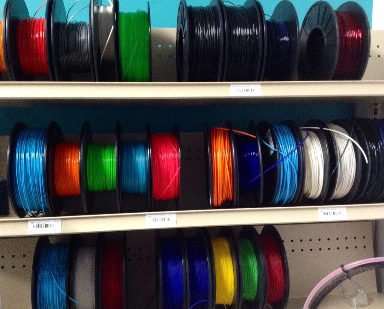 Shelves full of colourful filament spools