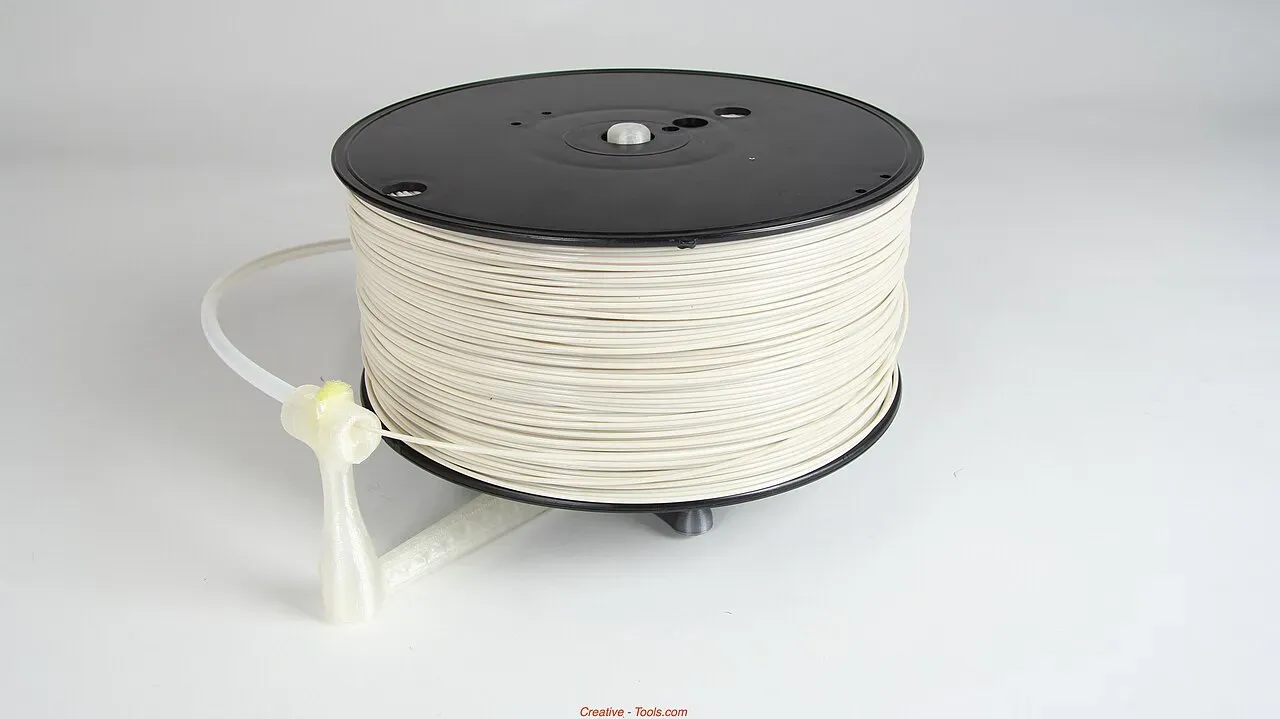 A spool of white 3D printing filament