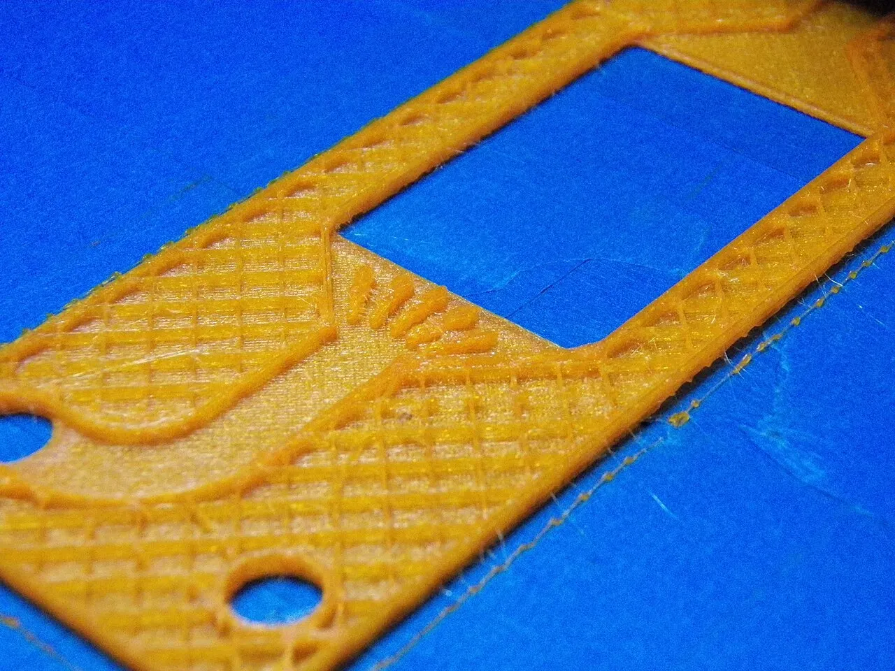 Close-up of an orange first layer on a blue bed surface