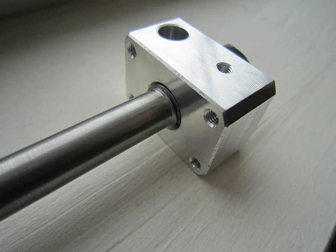 An aluminium hotend mount with a black nozzle