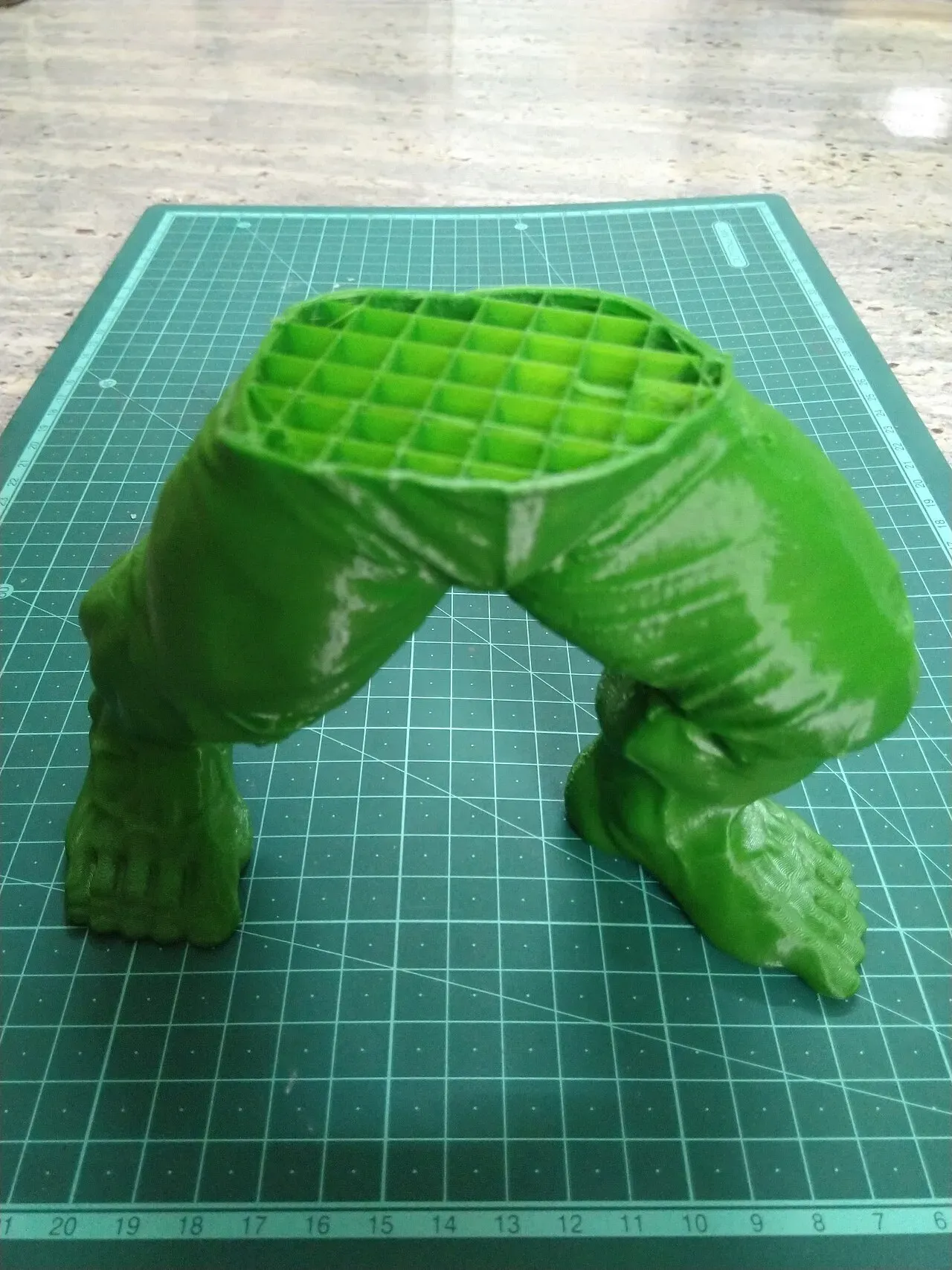 A half-printed figure showing its grid infill inside