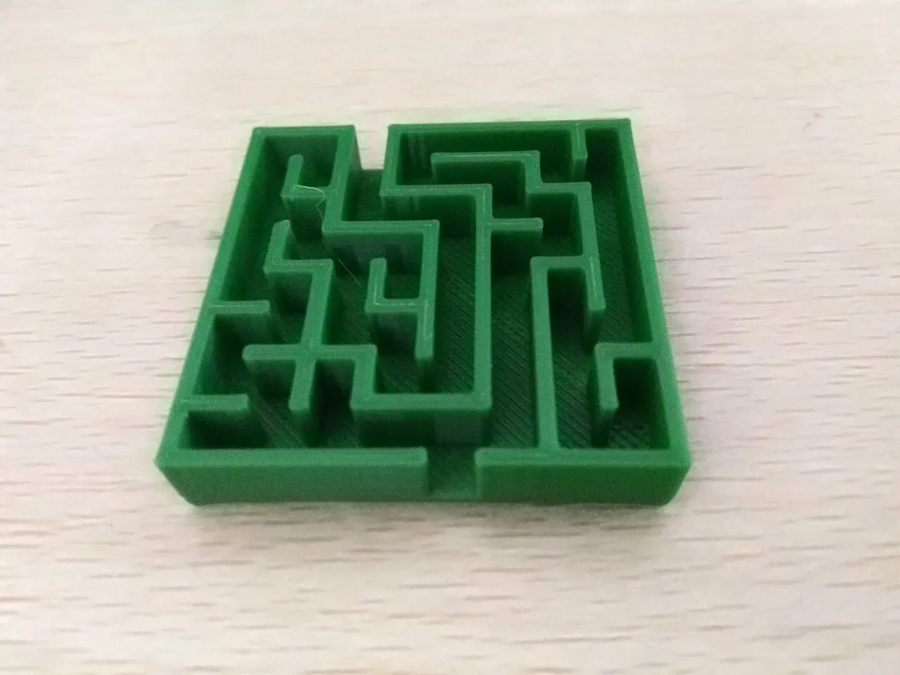 A green printed maze puzzle