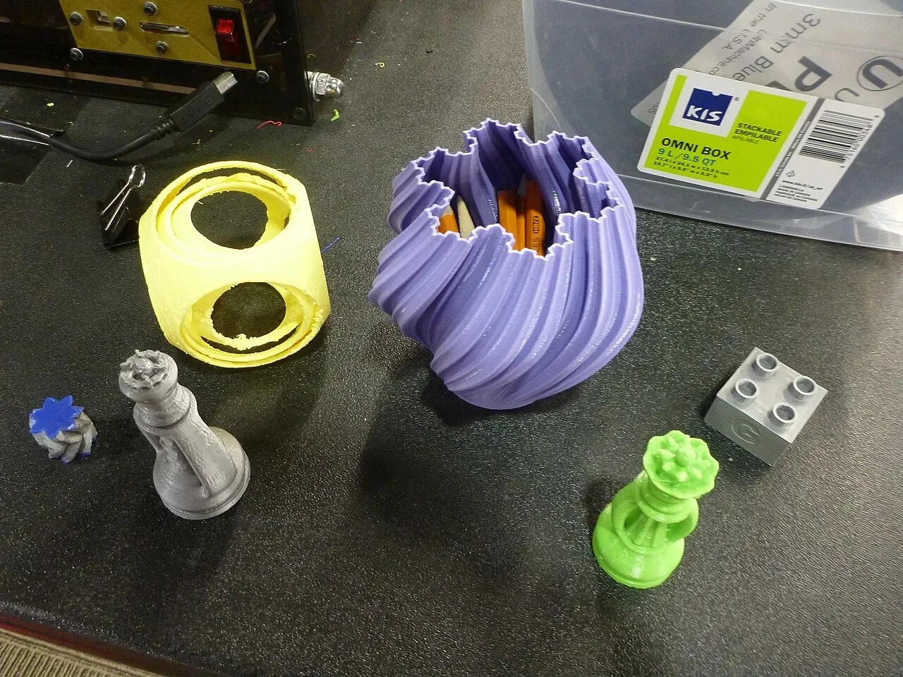 A table of assorted small 3D printed objects