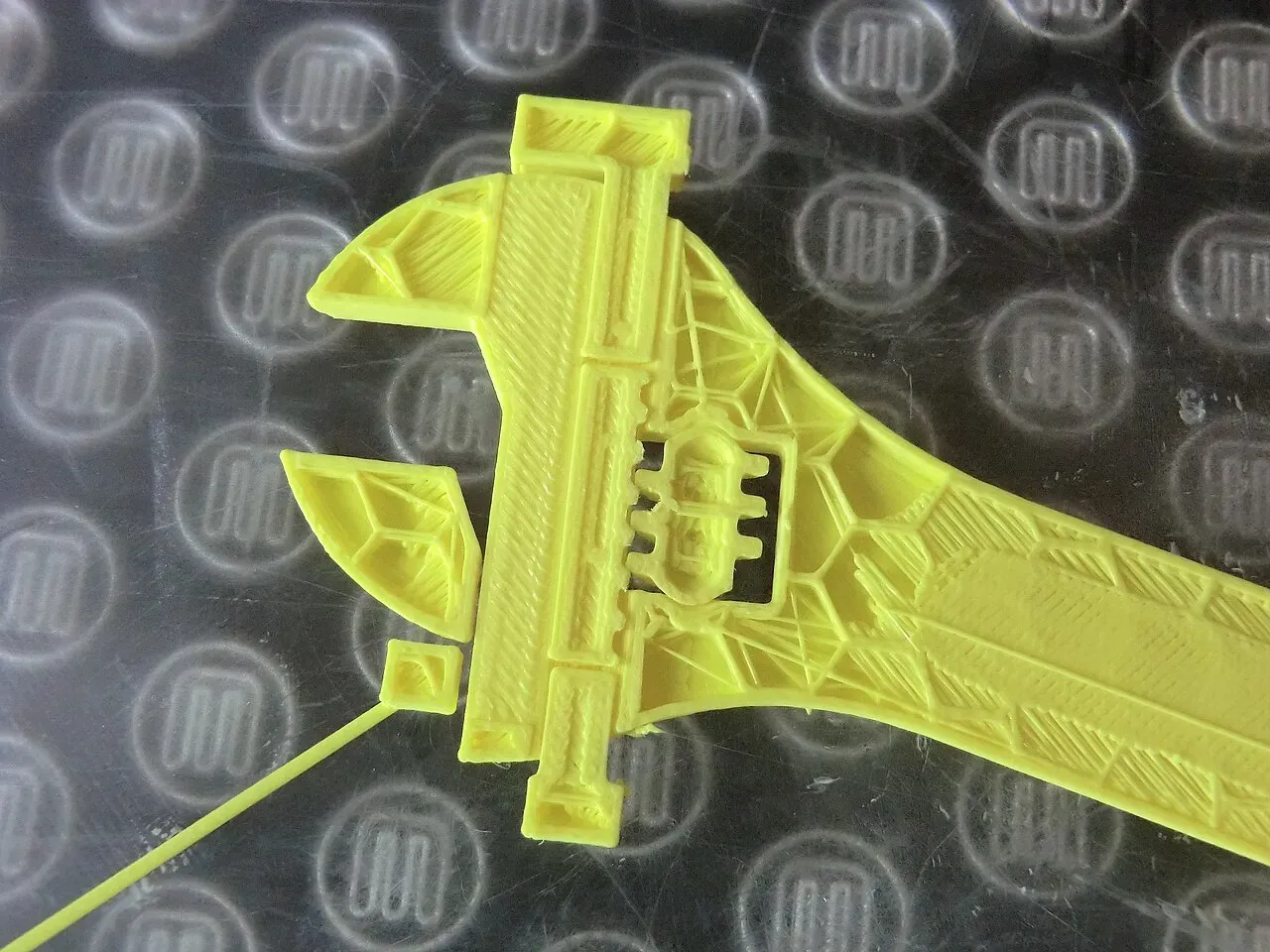 A yellow fully printed adjustable wrench