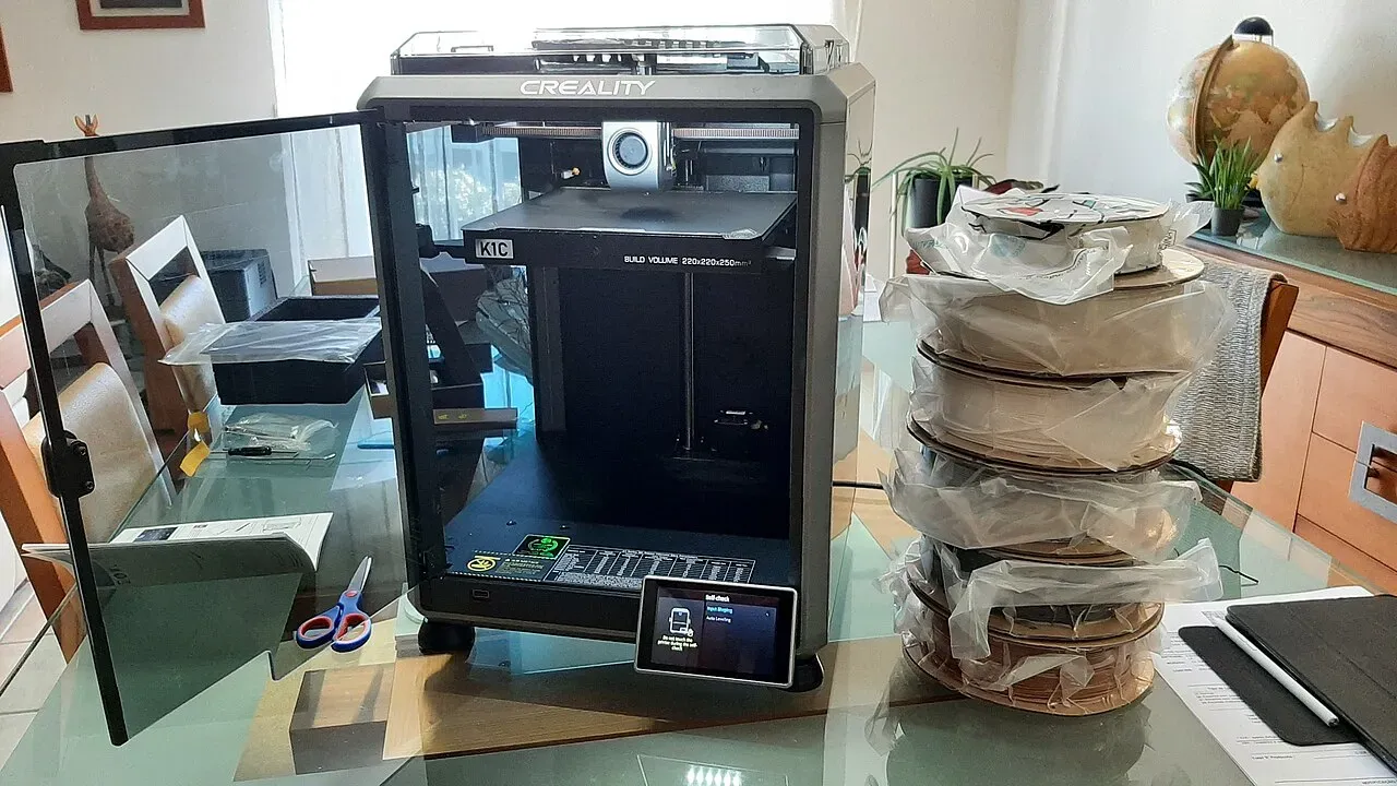 A Creality K1C enclosed printer on a desk