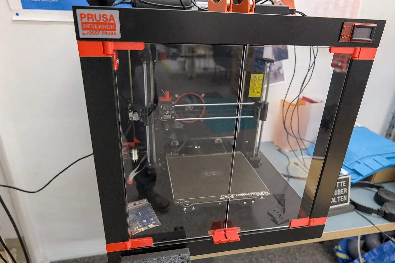 A Prusa printer inside a clear enclosure