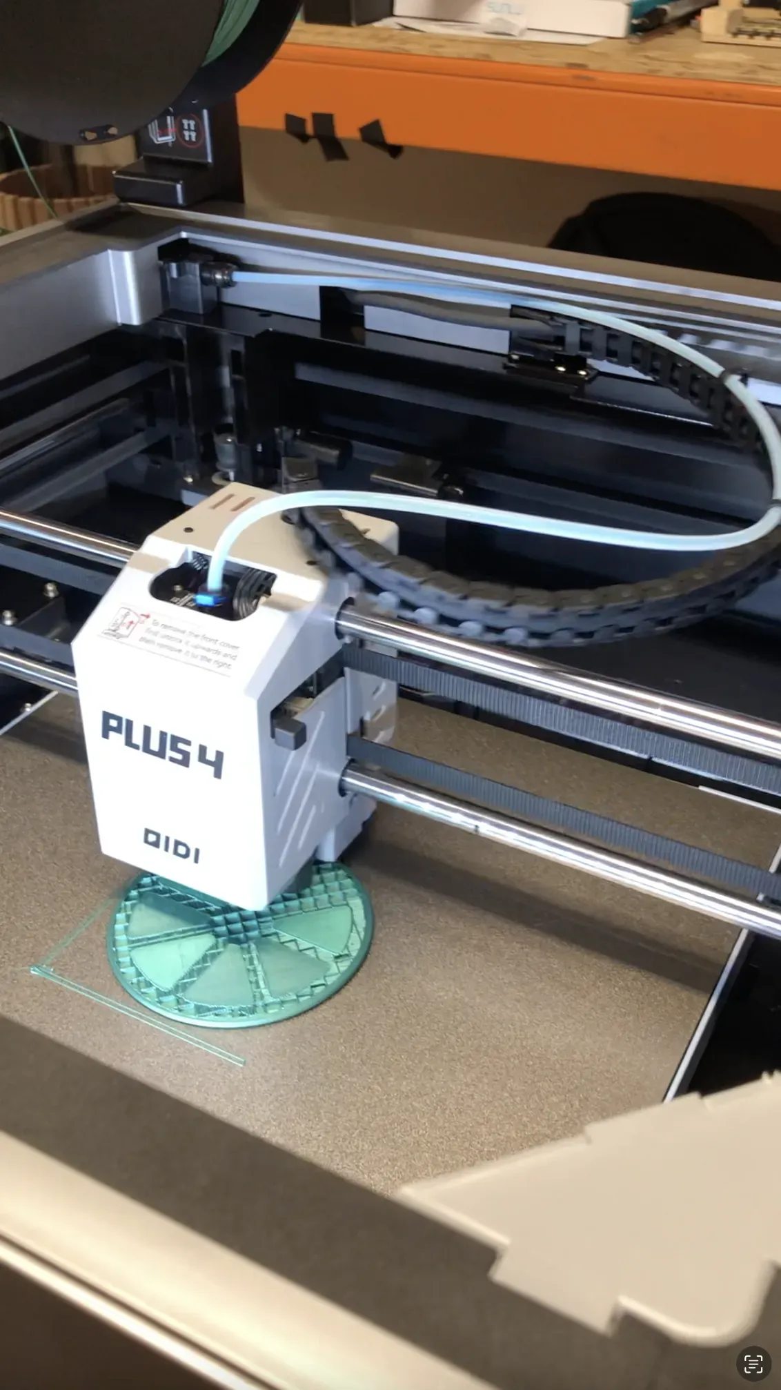 A QIDI printer print head with a filament tube